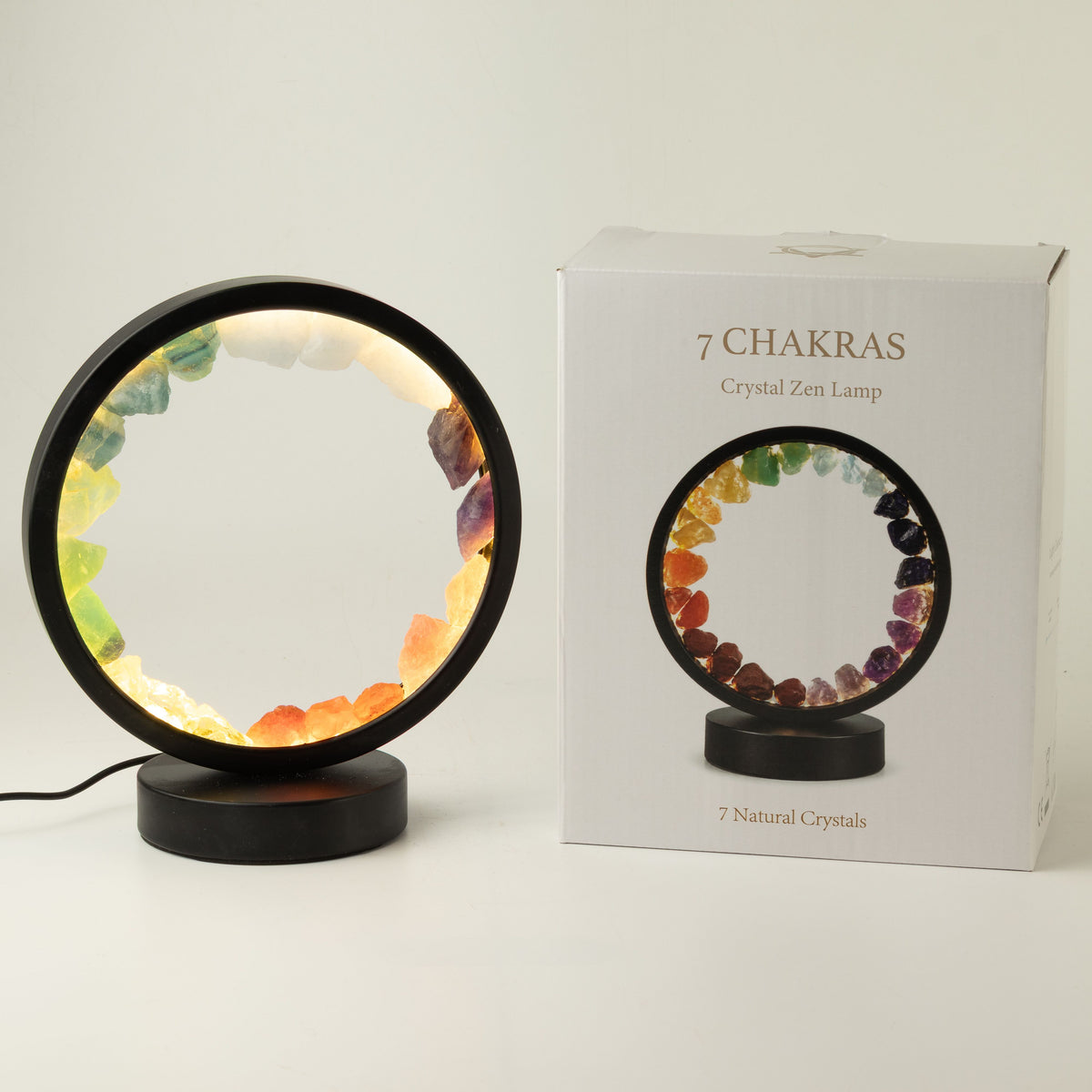Illuminated 7 chakra gemstone halo lamp on a black metal stand