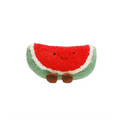 Smiling watermelon slice plush toy with red centre, green rind and small brown feet on a white background.